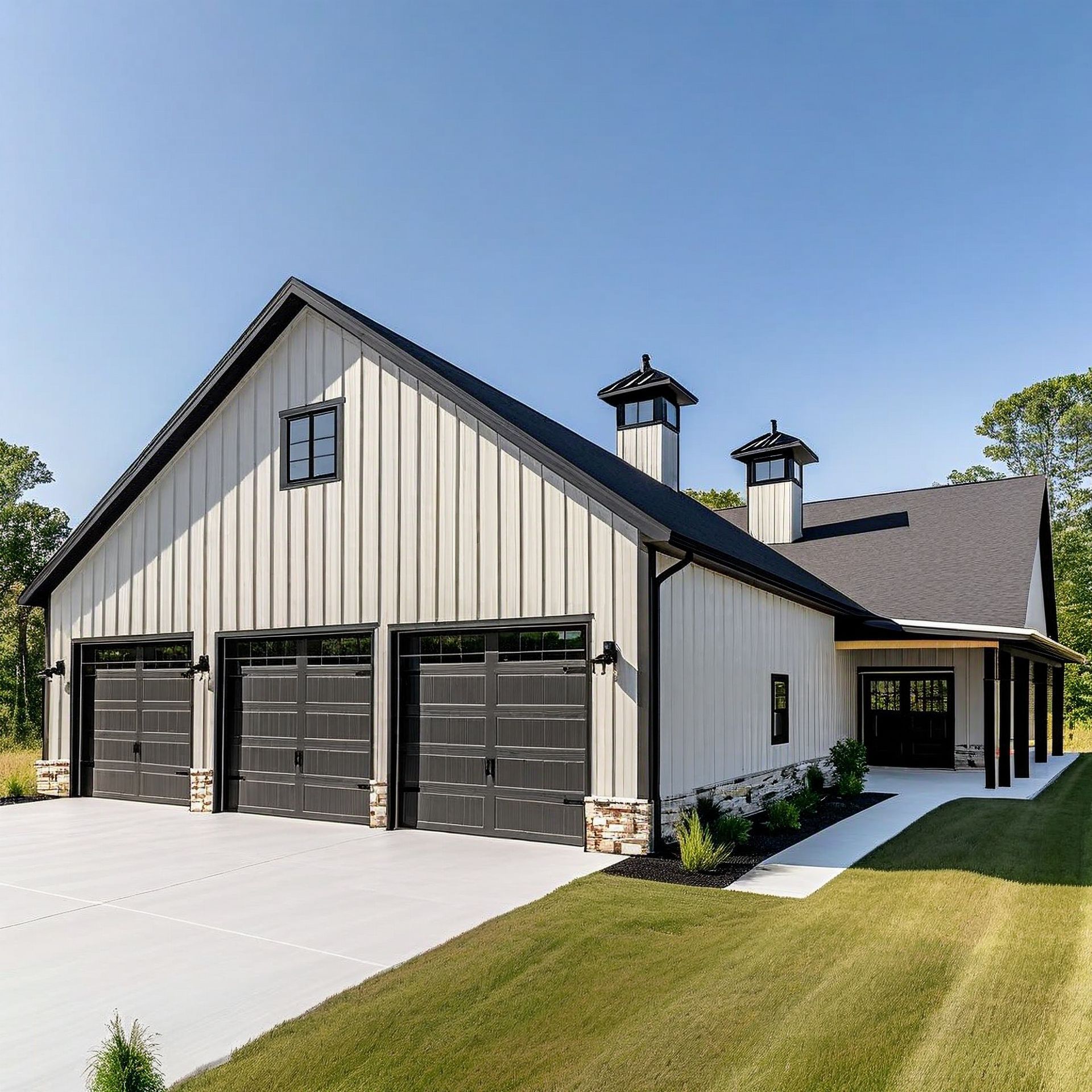 Modern barn-style house with three garage doors, light siding, black trim, and a covered porch.