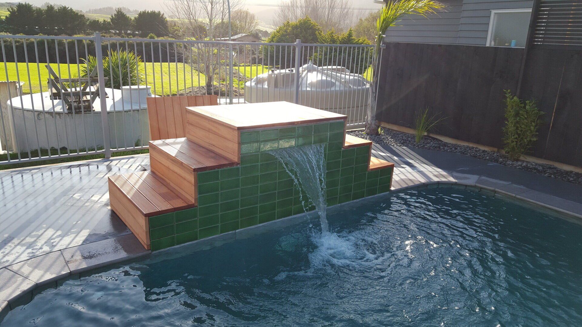 A waterfall is coming out of a swimming pool