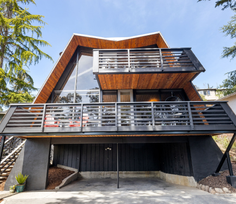 A house with a balcony and stairs leading up to it