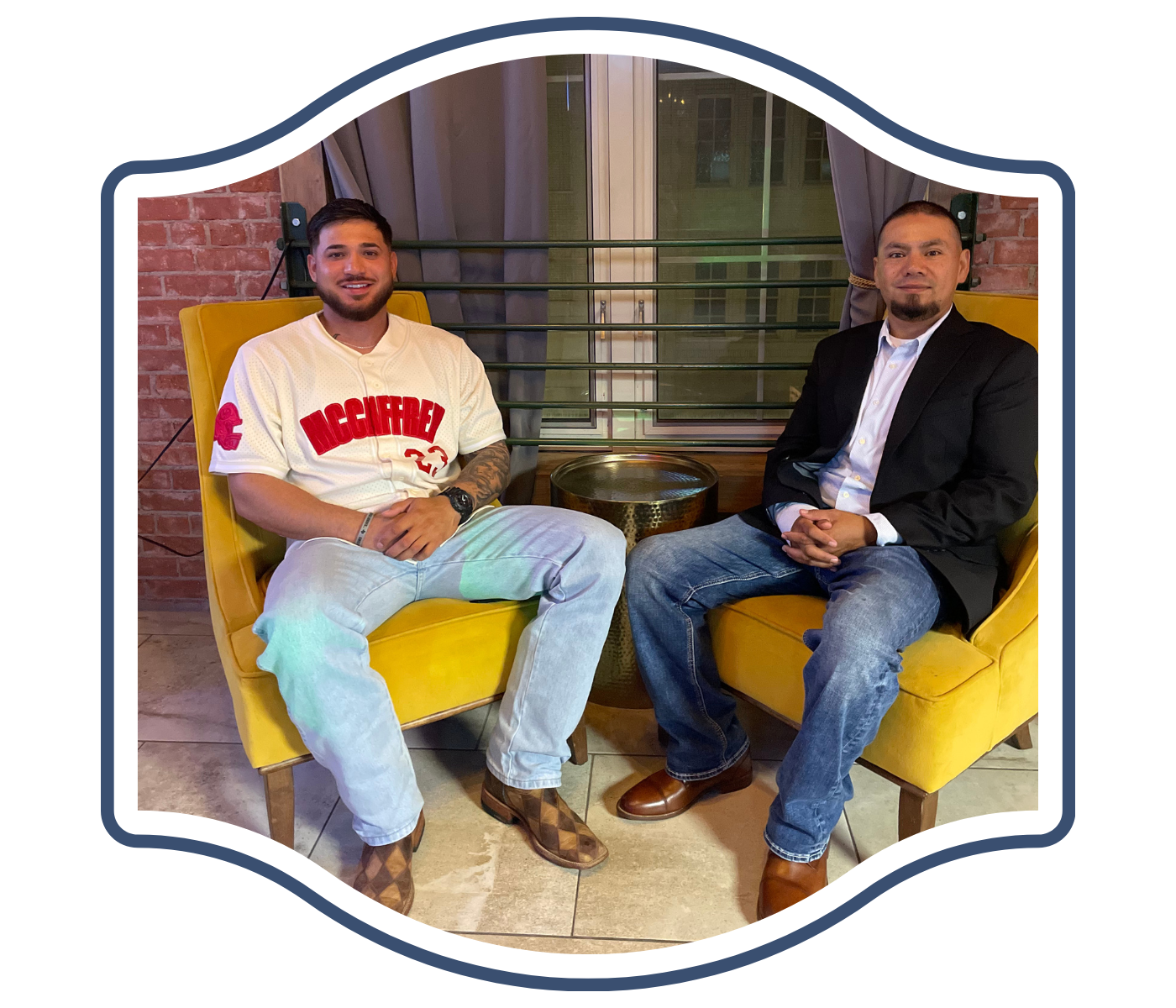 Club ELEV8 owners are sitting in yellow chairs in front of a window.