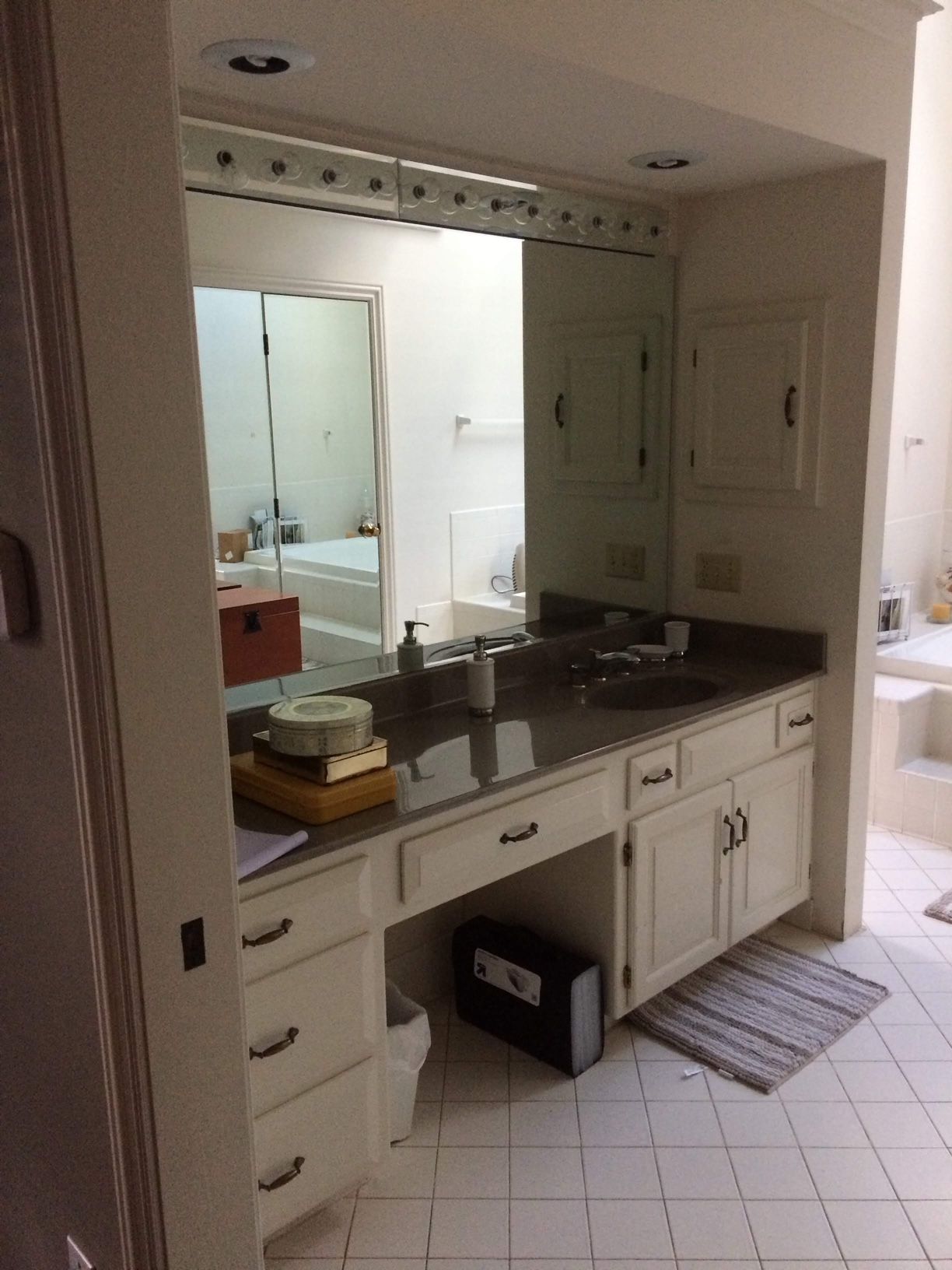 A bathroom with two sinks and a large mirror