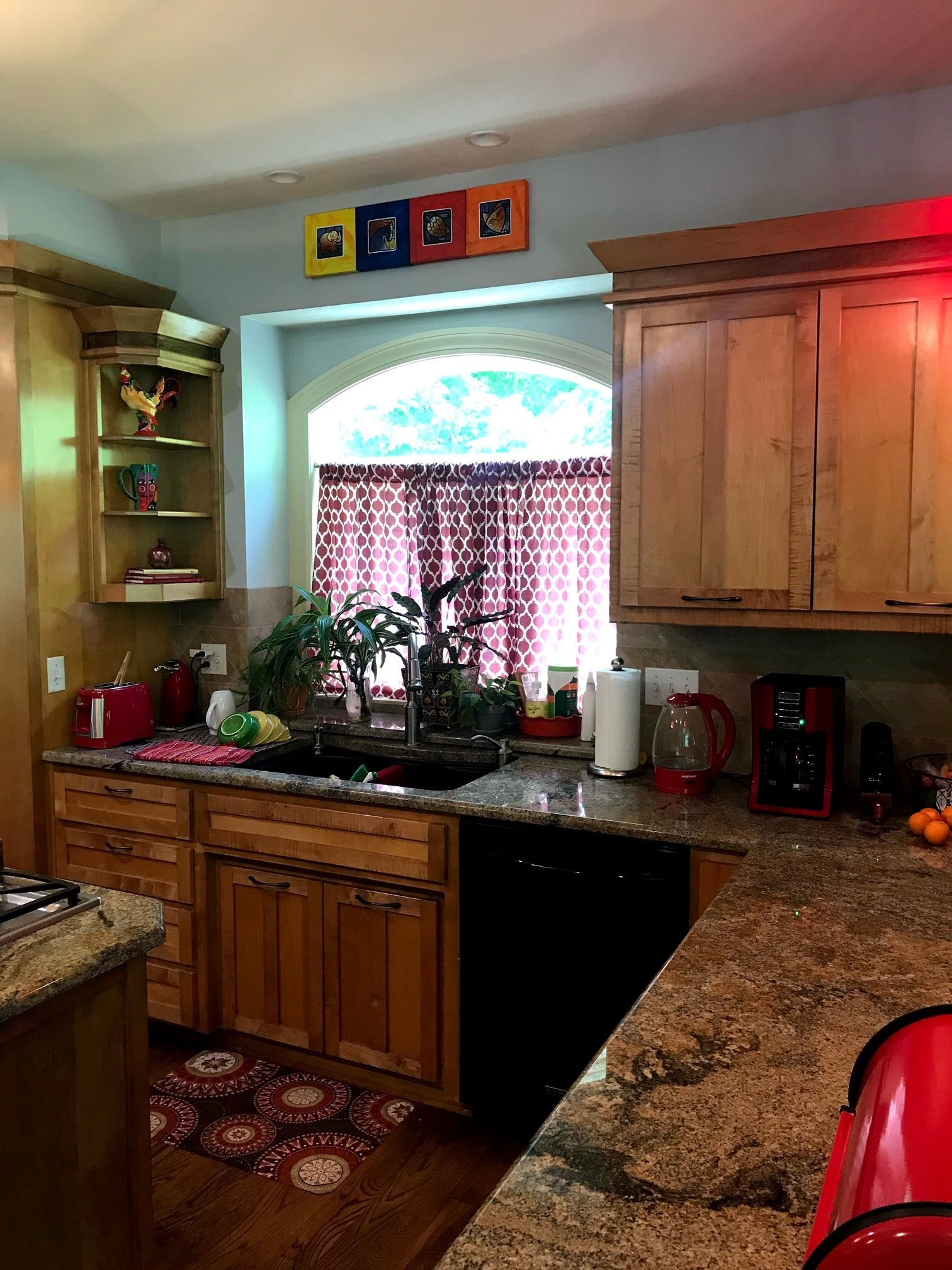 A kitchen with wooden cabinets and granite counter tops