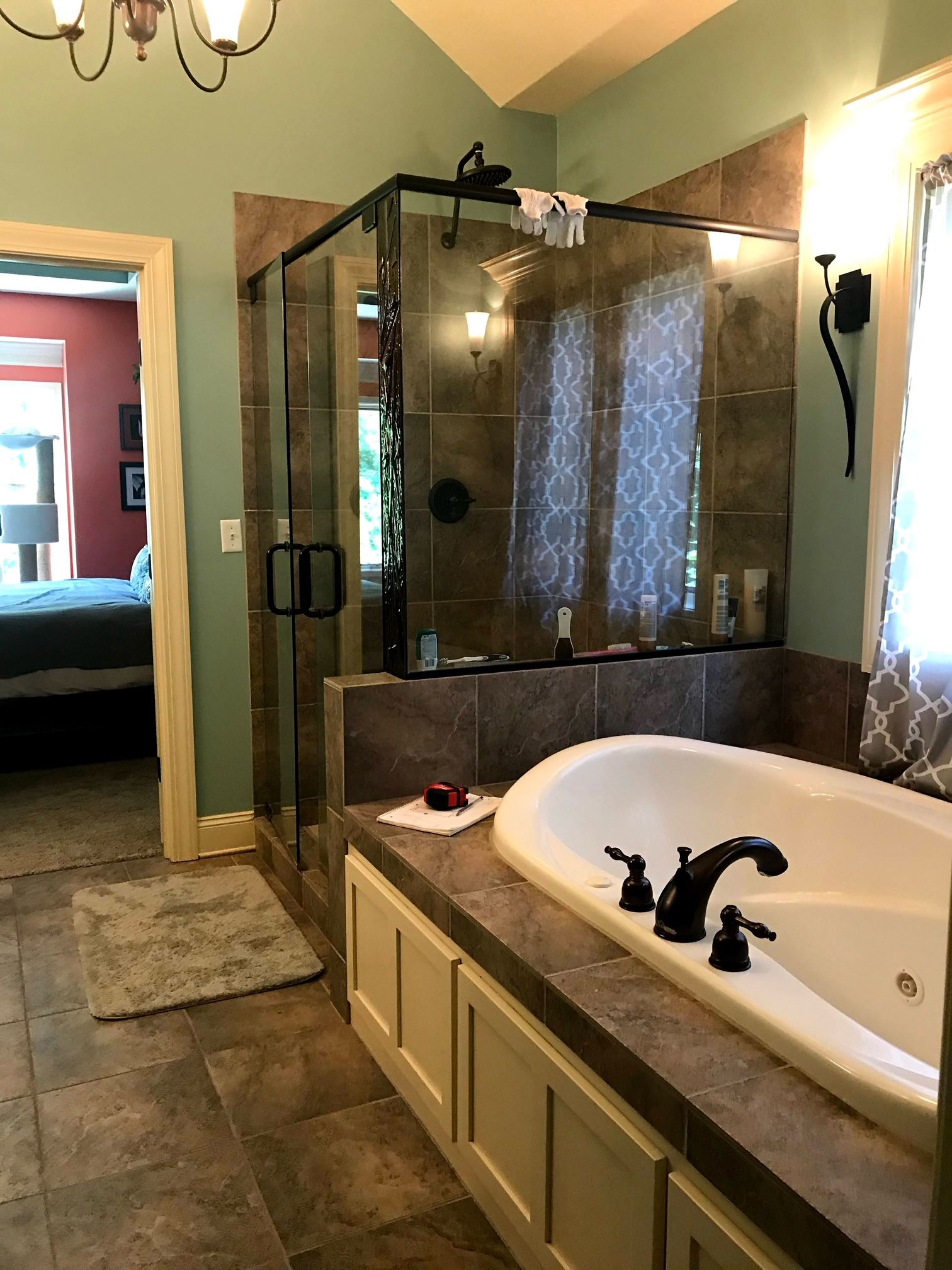 A bathroom with a large tub and a walk in shower.