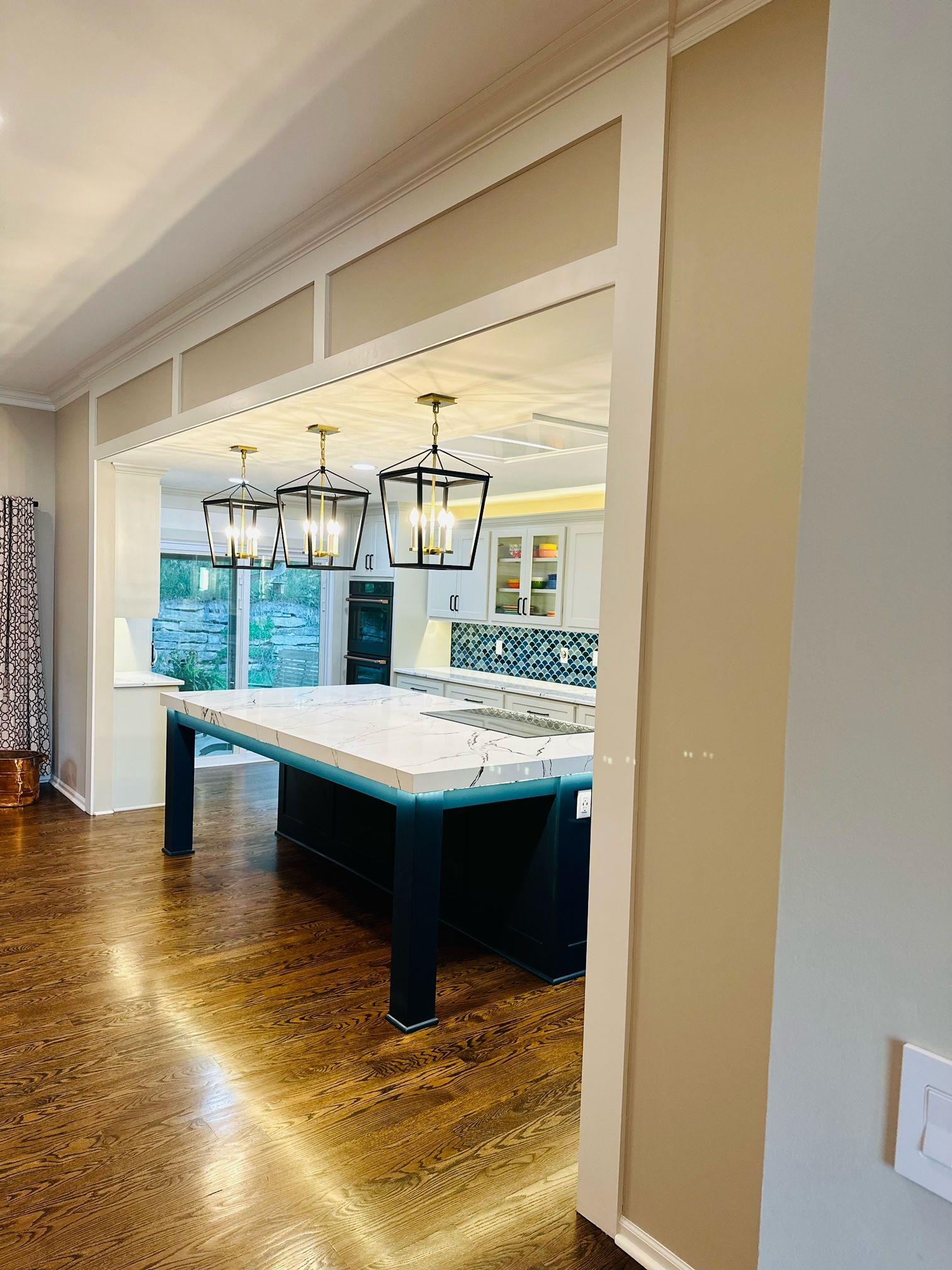 A kitchen with a pool table in the middle of it.
