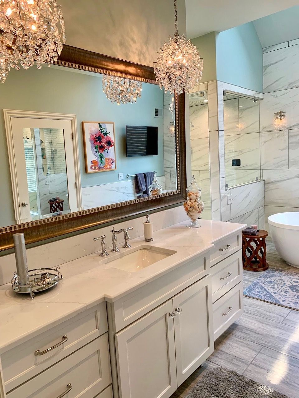 A bathroom with a sink , mirror and tub.