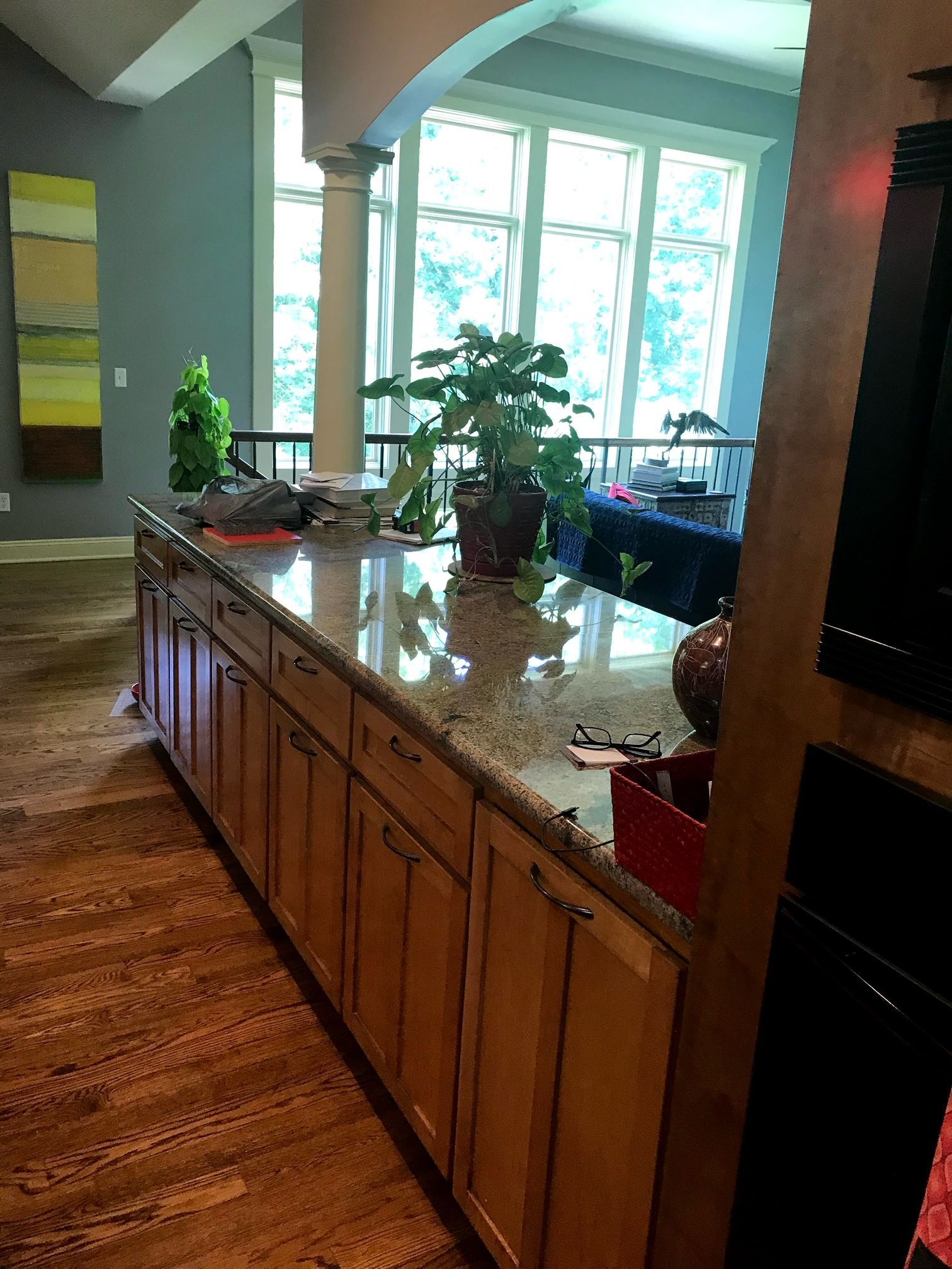 A kitchen with wooden cabinets and a granite counter top.