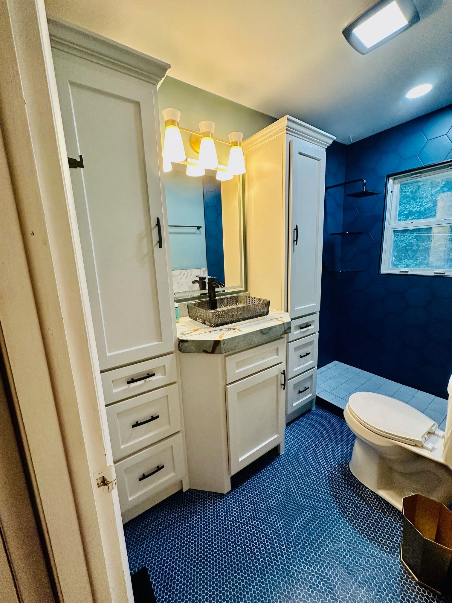 A bathroom with a sink , toilet , and mirror.