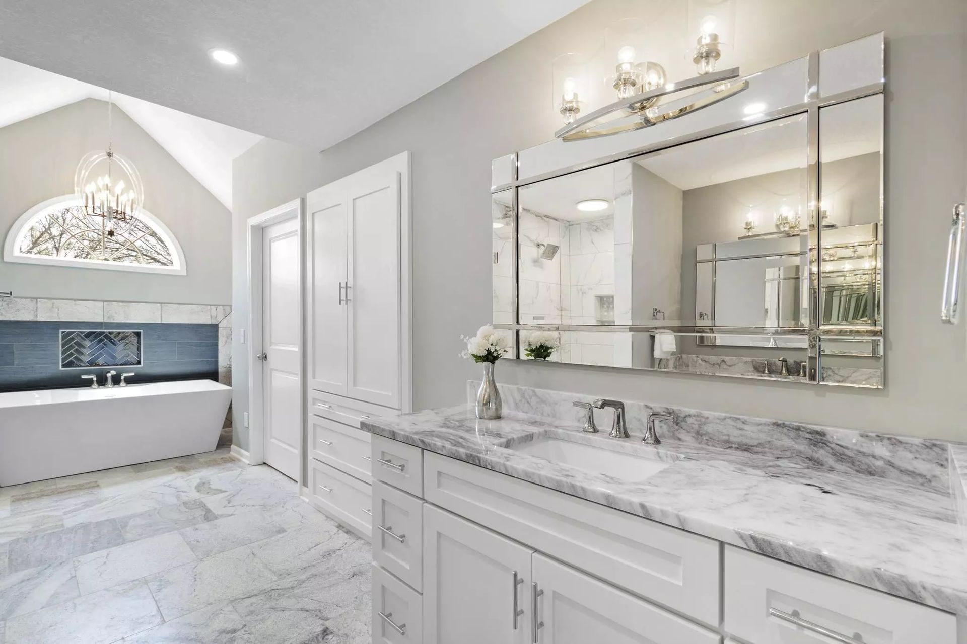A bathroom with two sinks and a large mirror.