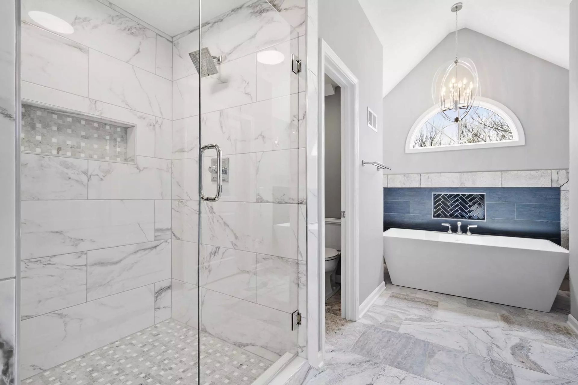 A bathroom with a walk in shower and a bathtub.