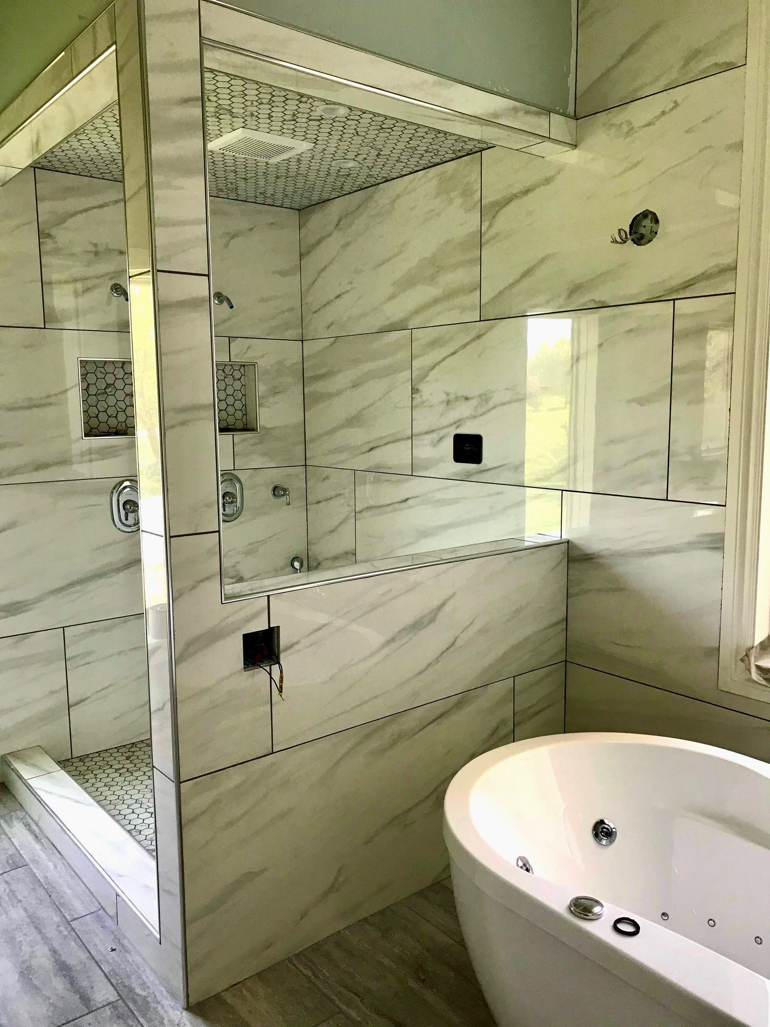 A bathroom with a bathtub and a walk in shower.