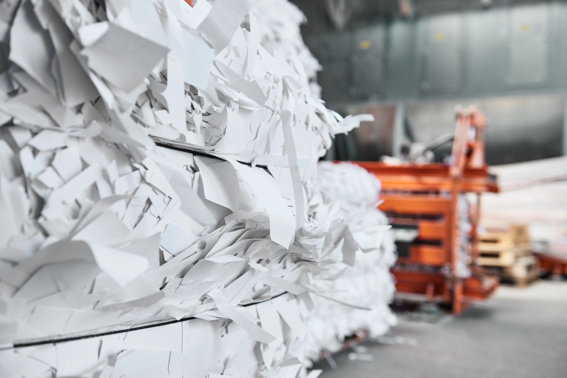 A pile of shredded paper is sitting on top of each other in a warehouse.