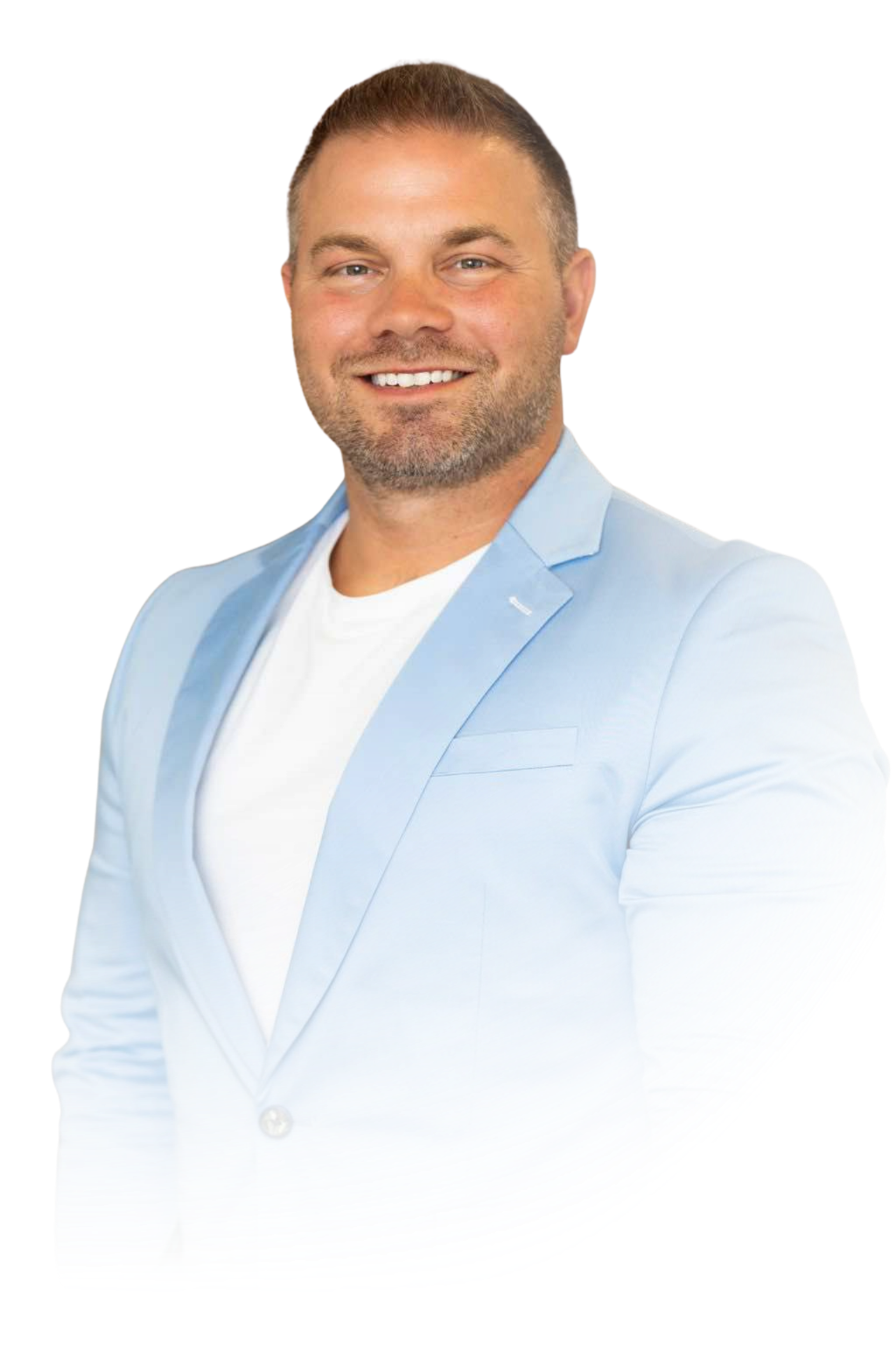 A man in a suit and glasses is sitting with his hands folded.