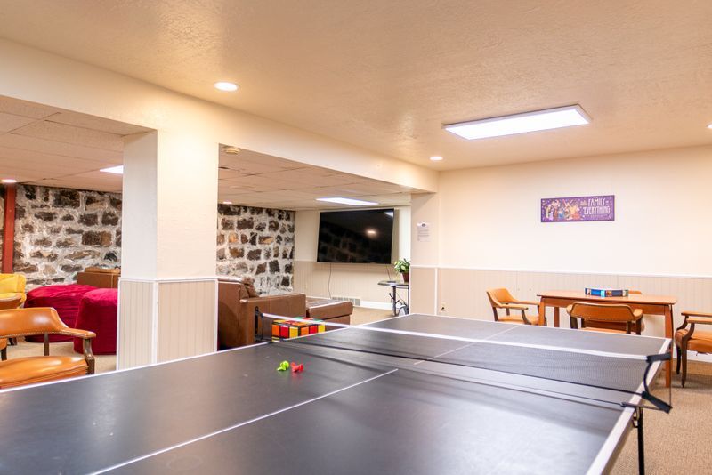 There is a ping pong table in the middle of the room.