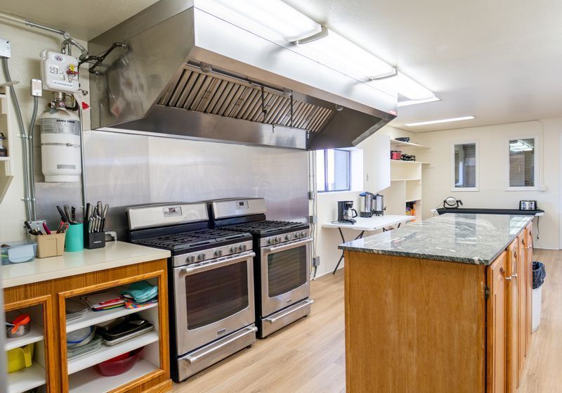 A kitchen with stainless steel appliances and wooden cabinets.