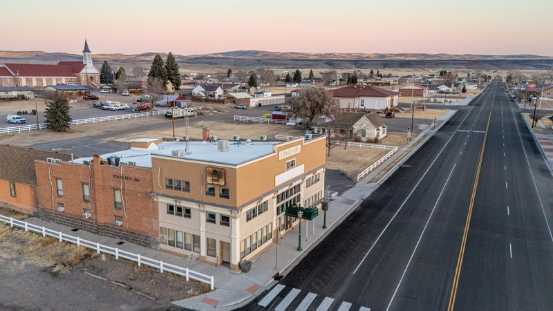 An aerial view of a small town next to a highway.