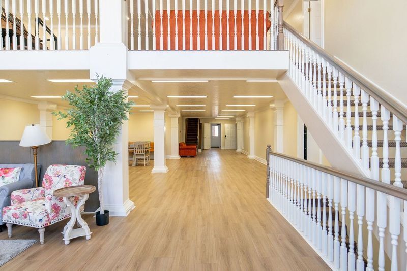 A living room with a staircase leading up to the second floor.