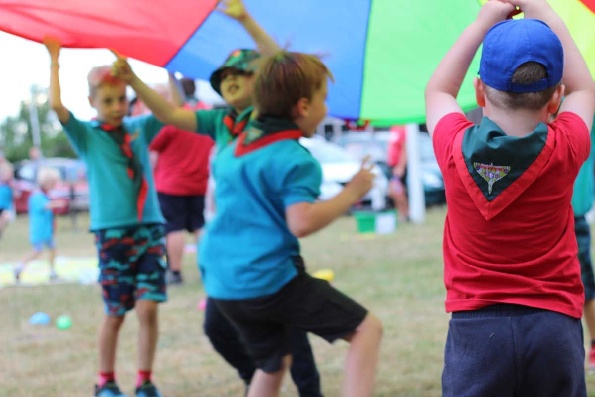 Scouts in Lincoln – 10th Lincoln Beavers and Cubs at Altham Terrace fun day, playing parachute games outdoors.