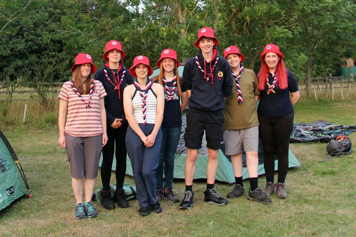 The Amazing Red Barrows team from Wragby Explorer Scouts, wearing red hats and neckers, ready to beg