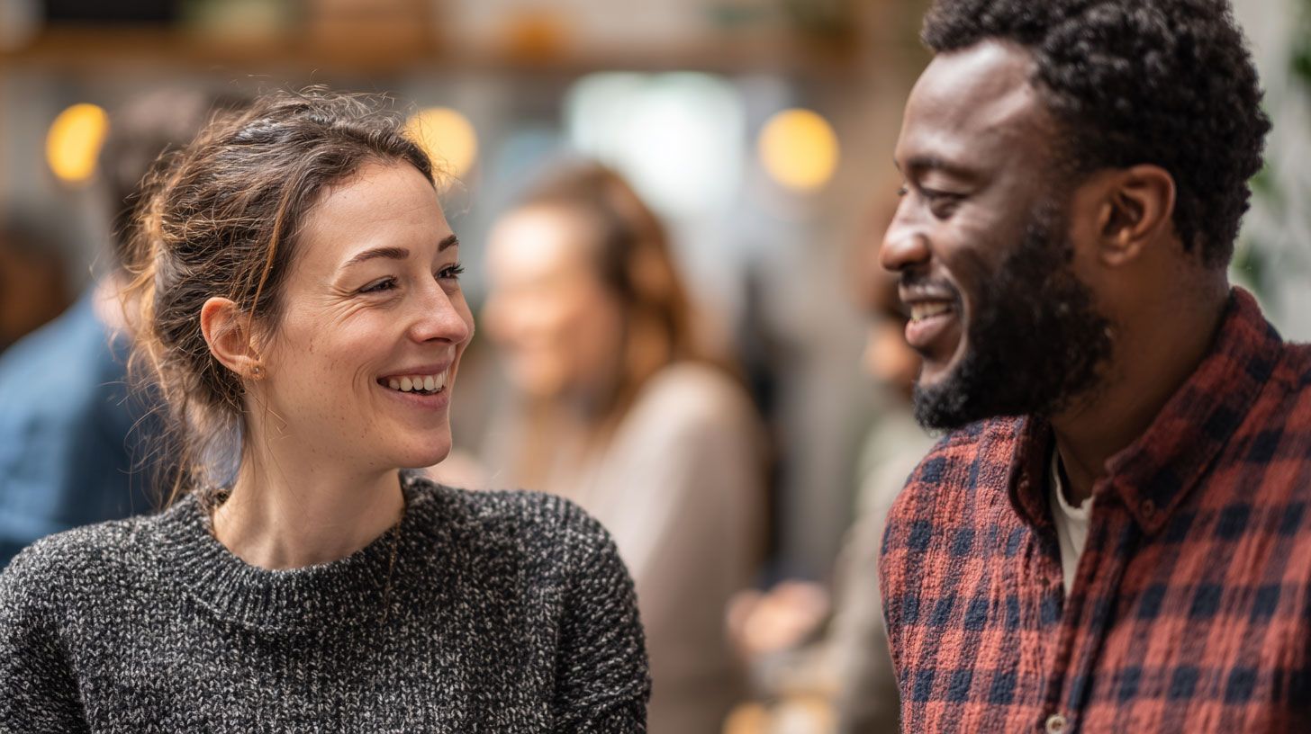 Two friendly charity trustees chatting together in a welcoming community setting.