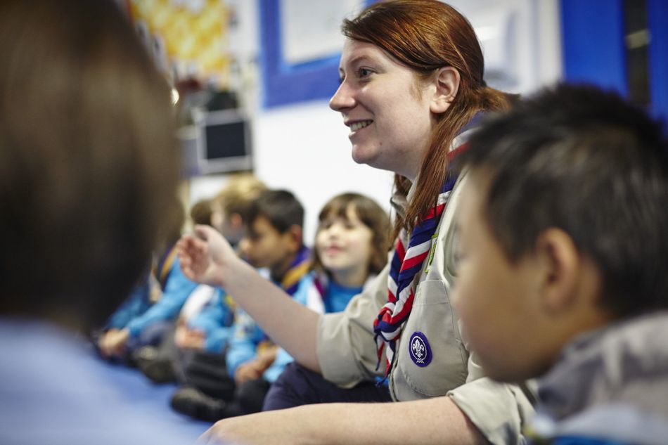 Adult volunteer supporting Beaver Scouts during a meeting, helping young people learn and grow through Scouting.
