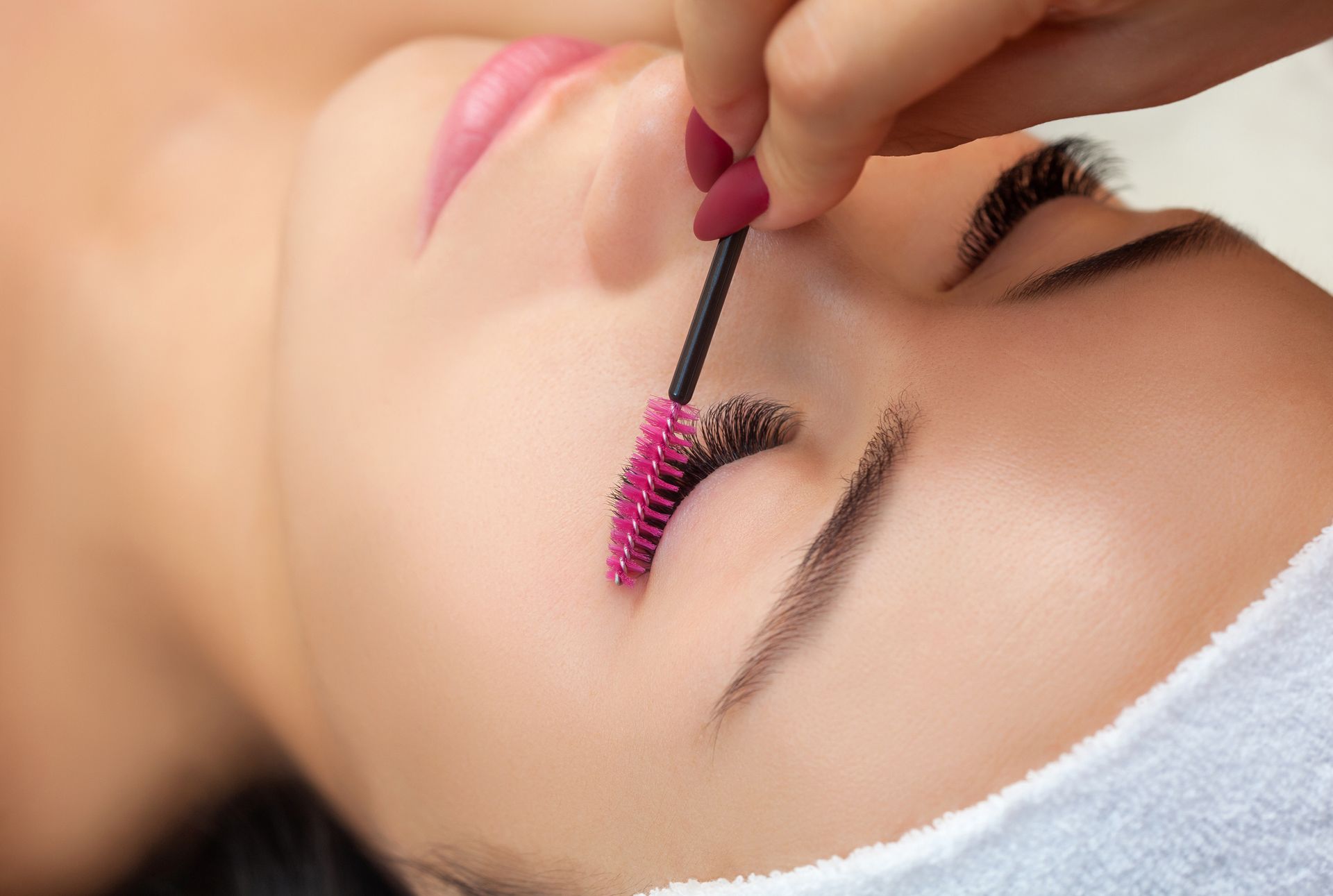 A woman is getting her eyelashes done at a beauty salon.