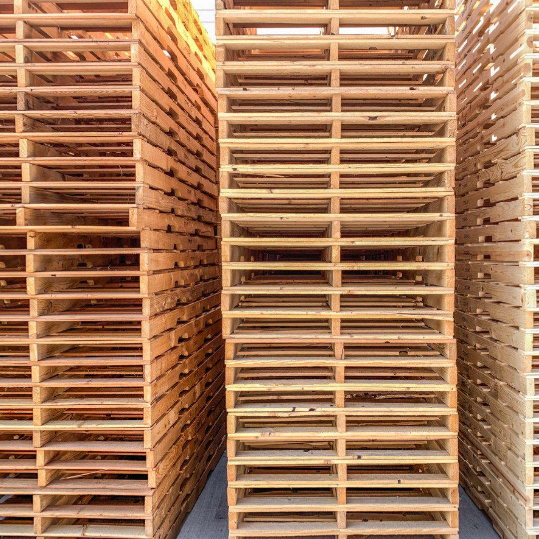 A row of wooden pallets stacked on top of each other in a warehouse.