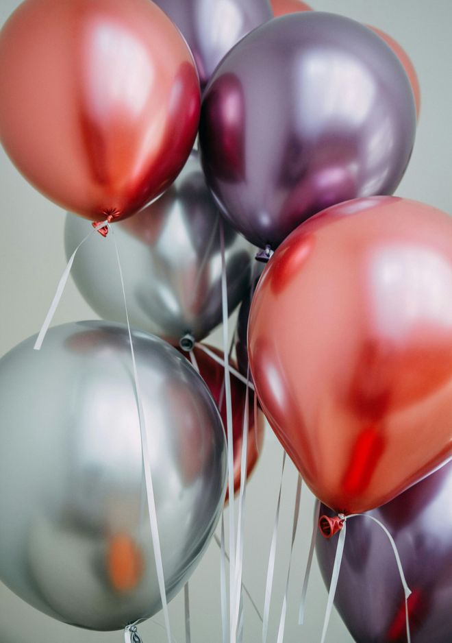 Balloons: Red, silver, and purple metallic balloons tied together.