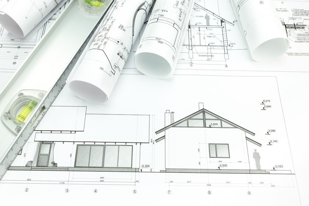Architectural Blueprints and a Level Tool on a White Surface — Mid North Coast Drafting & Construction in Harrington, NSW