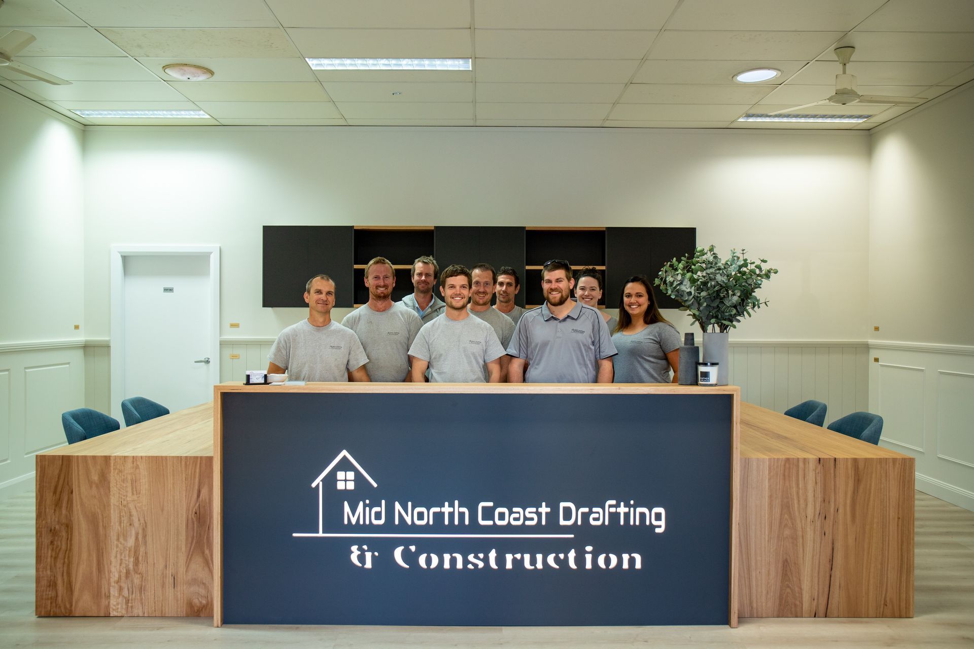 Group of Eight People in Matching Uniforms