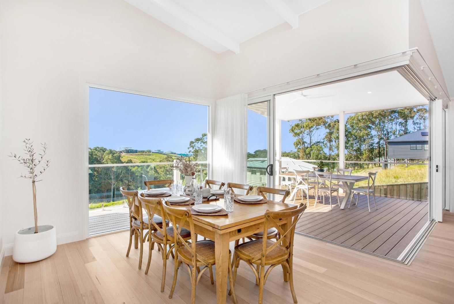 Dining Room With Wooden Table and Deck Access — Mid North Coast Drafting & Construction in Taree, NSW