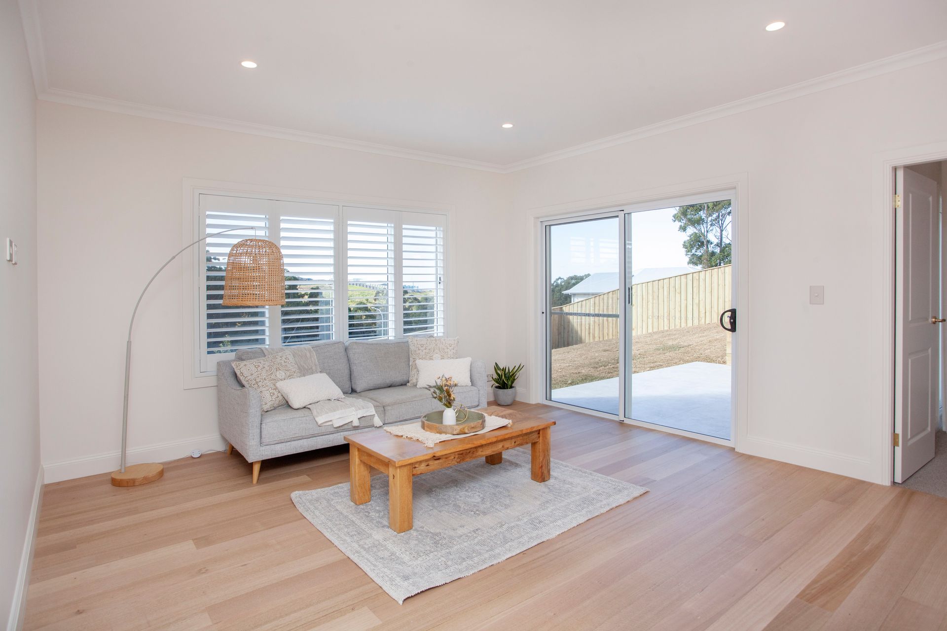 Living Room With Gray Sofa and Wooden Coffee Table — Mid North Coast Drafting & Construction in Diamond Beach, NSW