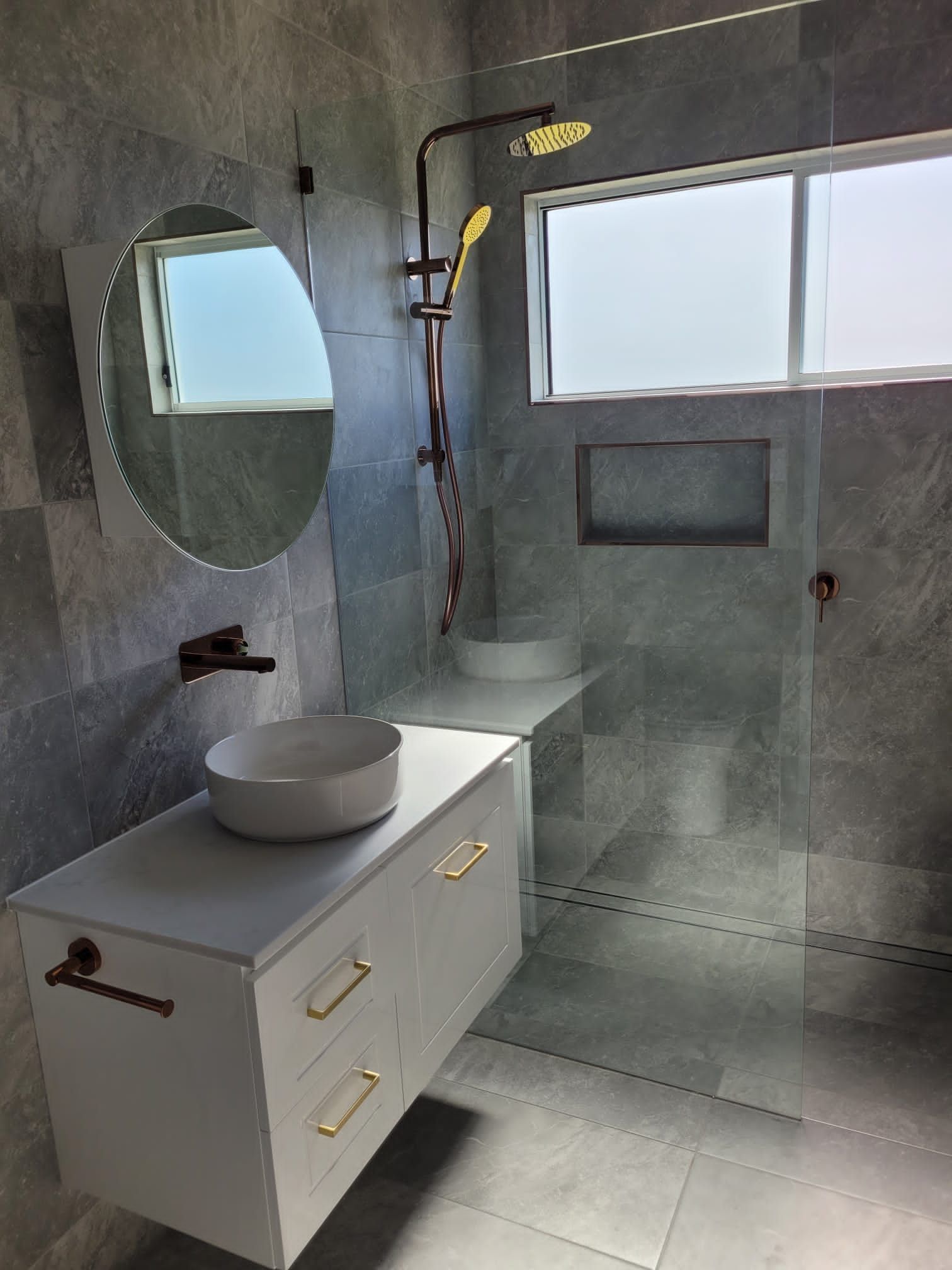 Modern Bathroom With White Floating Vanity and Copper Fixtures — Mid North Coast Drafting & Construction in Taree, NSW
