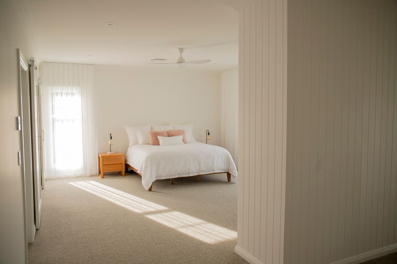 Bright Bedroom With White Bedding and Sunny Window — Mid North Coast Drafting & Construction in Taree, NSW