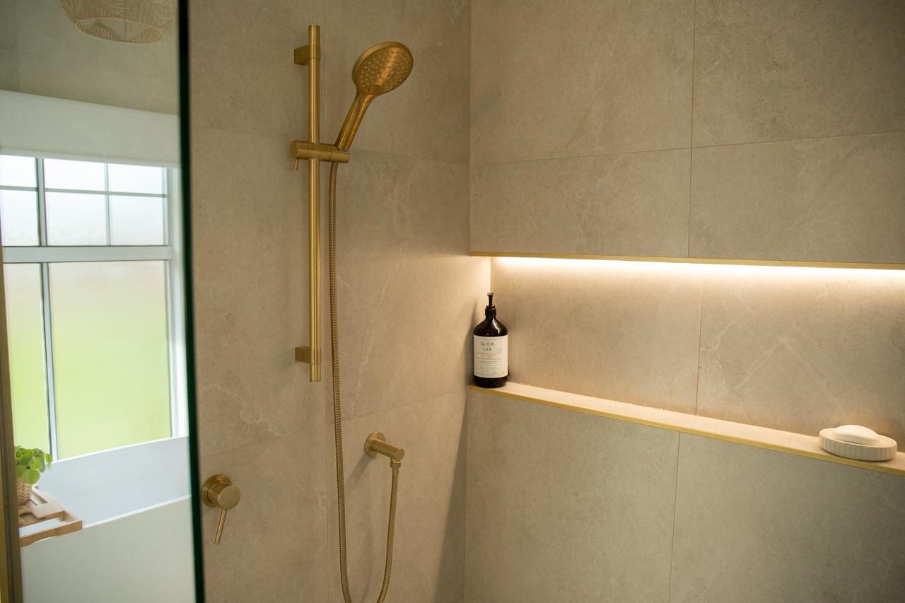 Gold Shower Fixtures in Tiled Niche With Window — Mid North Coast Drafting & Construction in Taree, NSW