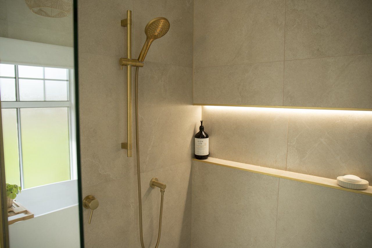 Gold Shower Fixtures With Built-In Shelf and Beige Tile — Mid North Coast Drafting & Construction in Taree, NSW