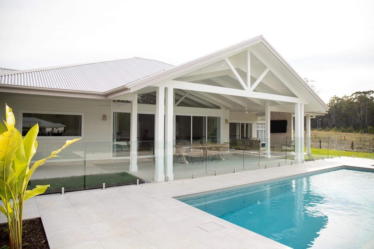 White House With Pool, Covered Patio, and Glass Railing — Mid North Coast Drafting & Construction in Taree, NSW