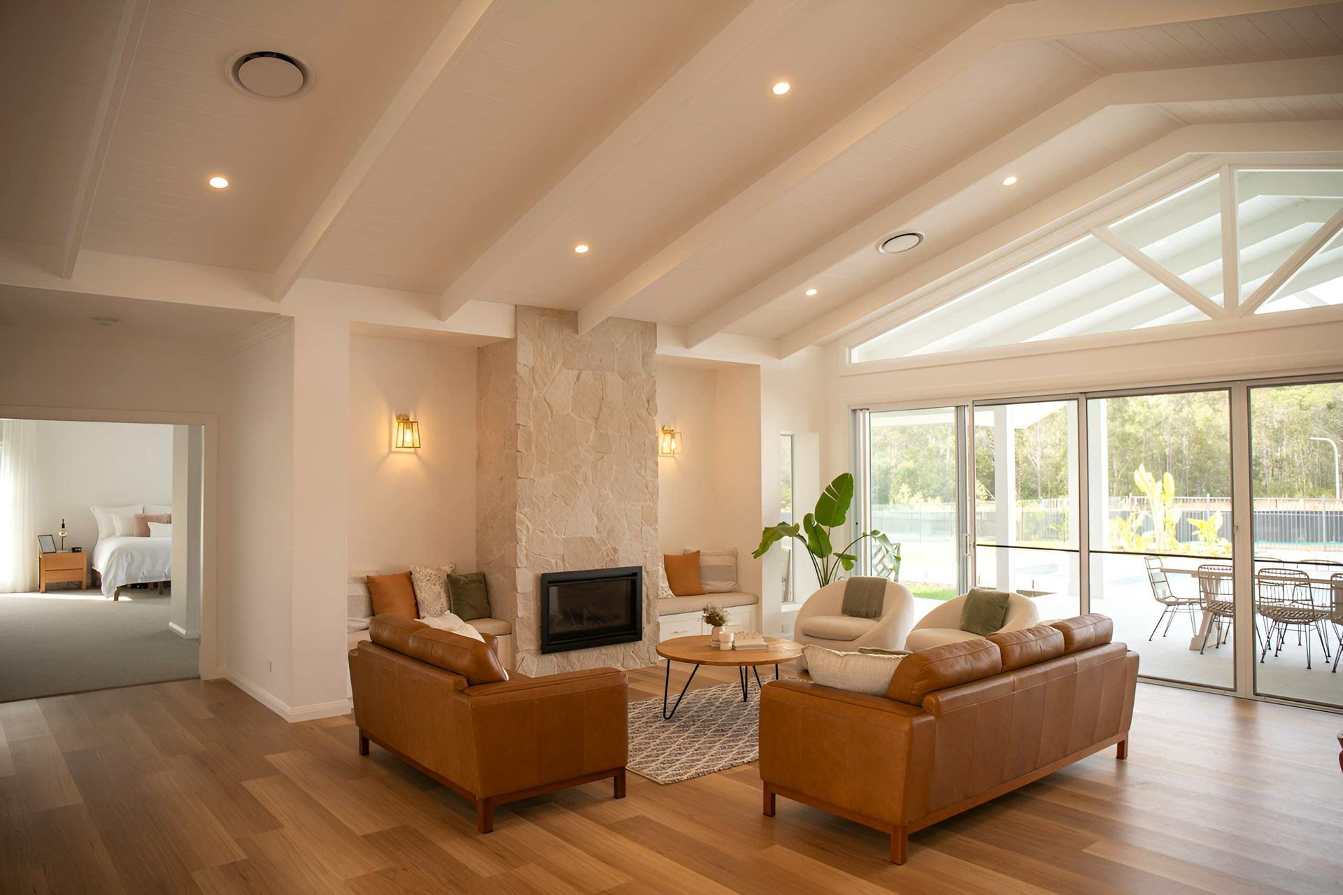 Spacious Living Room With Fireplace and Leather Sofas — Mid North Coast Drafting & Construction in Taree, NSW