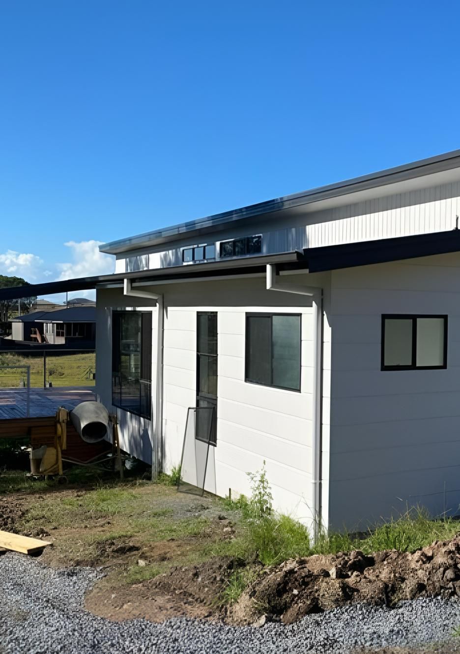 White Modern House With Black Trim on Construction Site — Mid North Coast Drafting & Construction in Old Bar, NSW