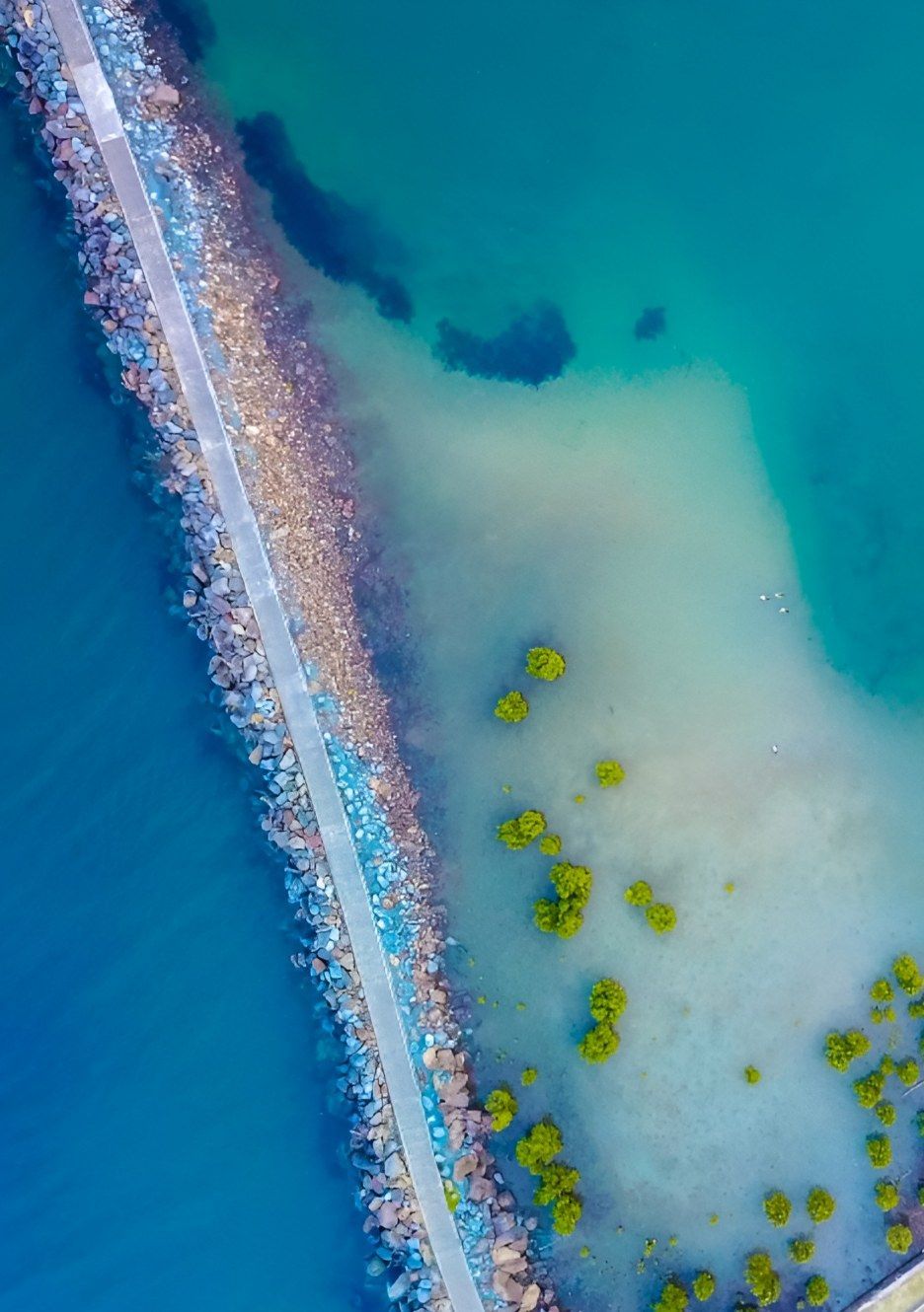 Aerial View of Stone Pier Extending Into Turquoise Water — Mid North Coast Drafting & Construction in Harrington, NSW
