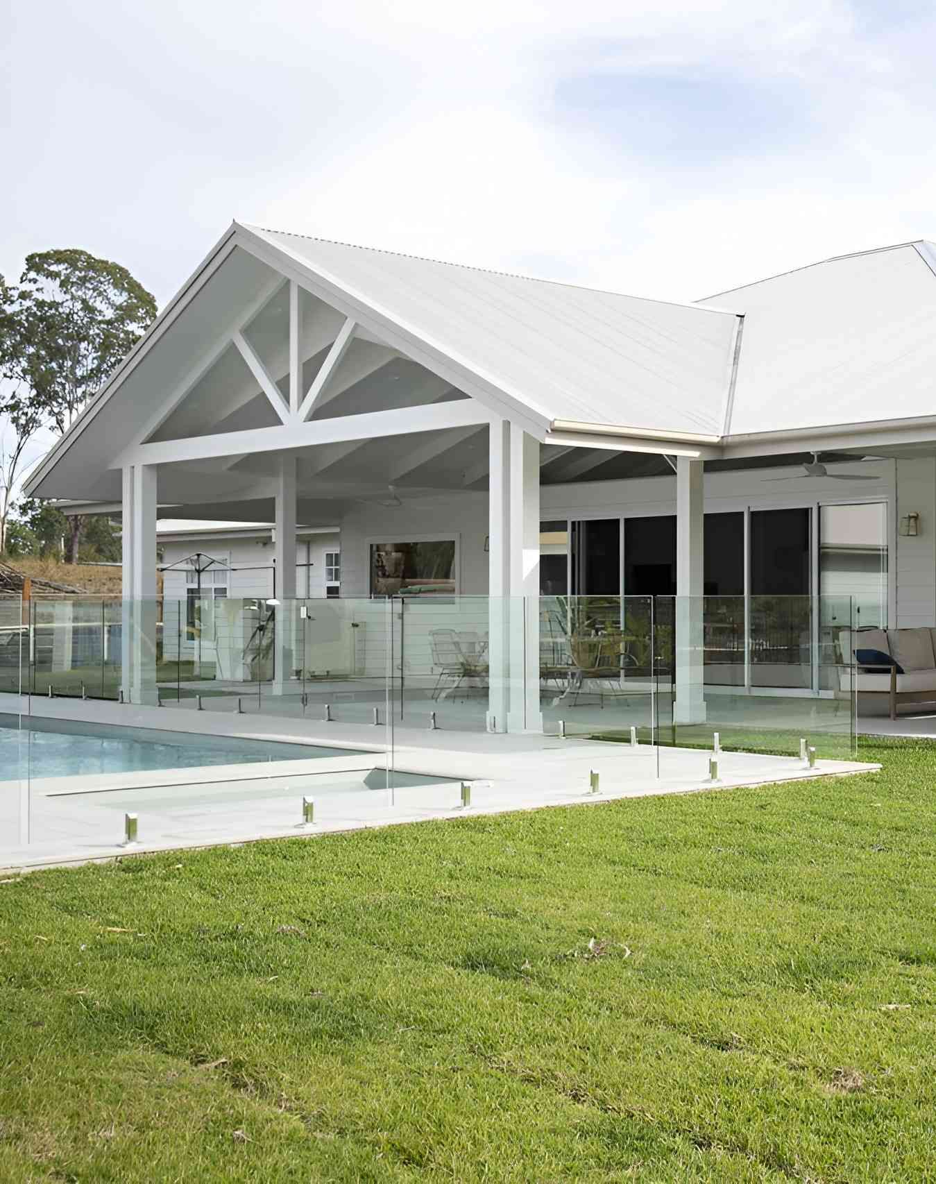 White House With Open-Air Patio, Glass Pool Fence, and Lawn — Mid North Coast Drafting & Construction in Forster, NSW