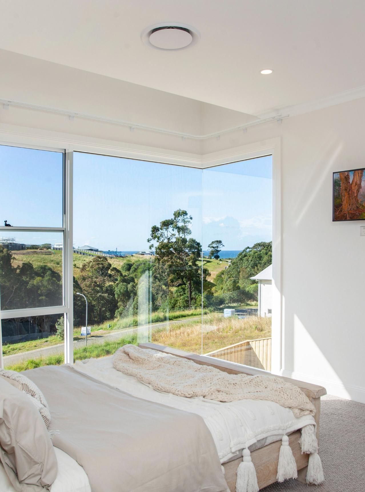 Bedroom With Large Window Overlooking Scenic Landscape and Ocean — Mid North Coast Drafting & Construction in Old Bar, NSW