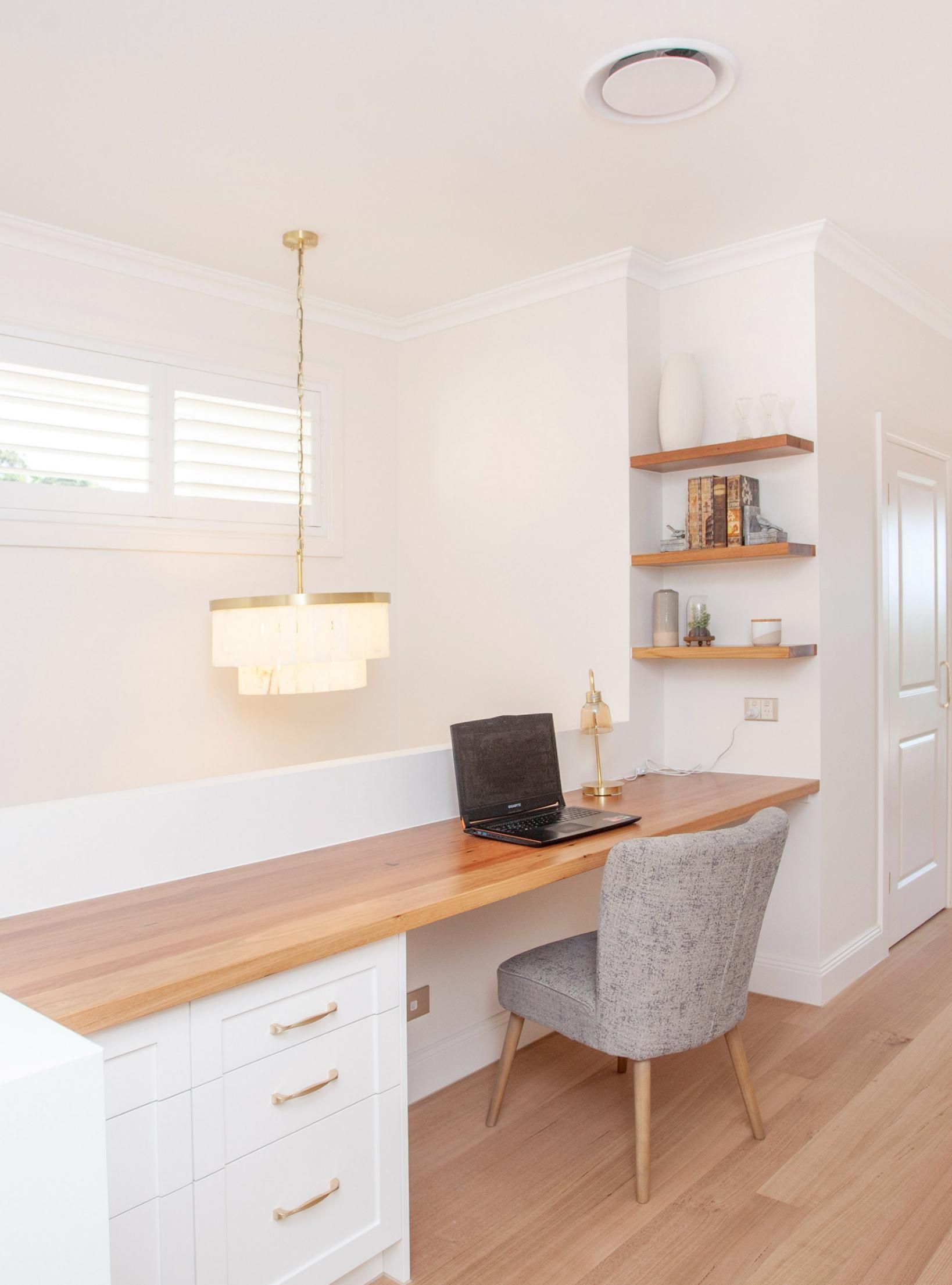 Home Office With Wooden Desk, Laptop, and Shelving — Mid North Coast Drafting & Construction in Diamond Beach, NSW