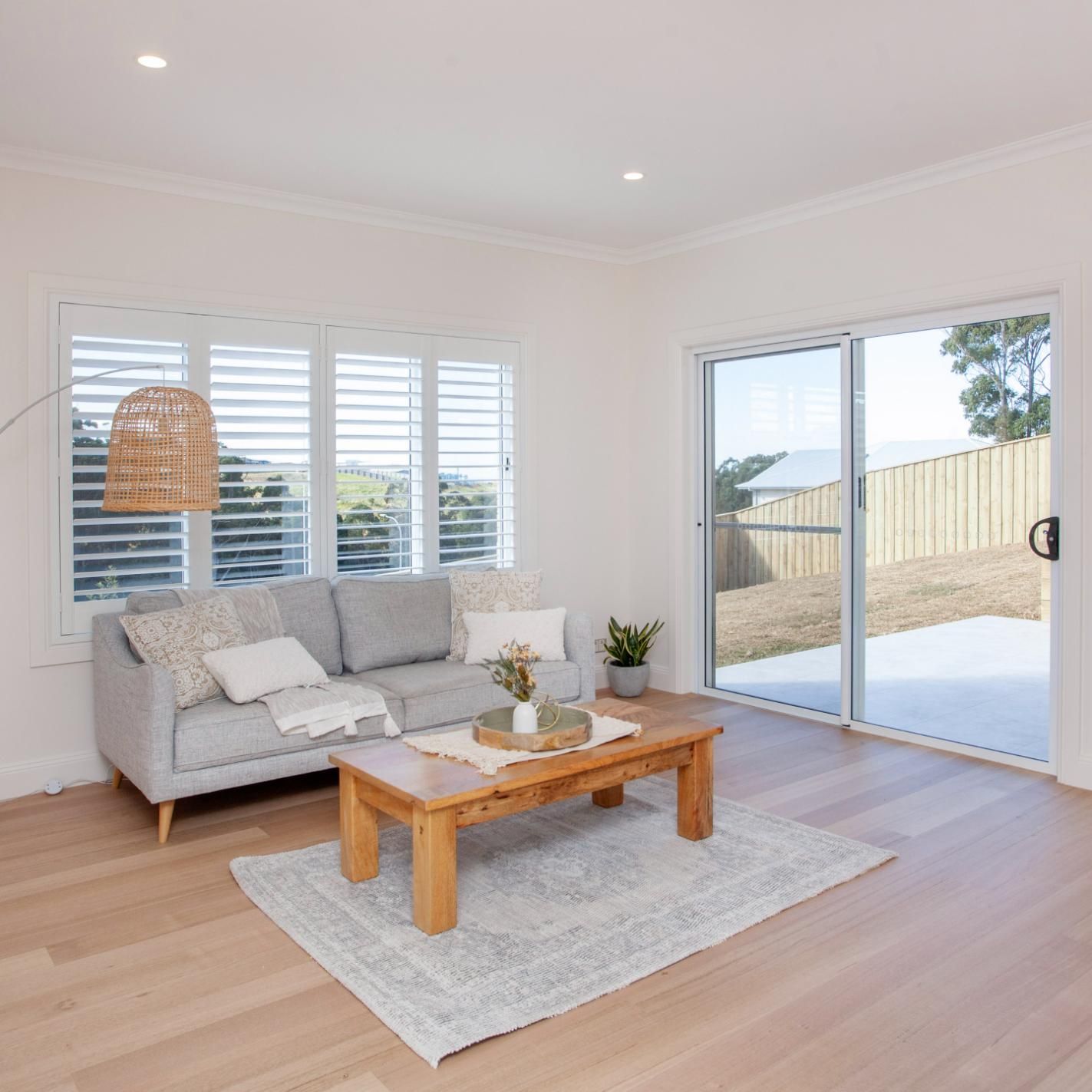 Living Room With Grey Sofa, Coffee Table, and Sliding Door — Mid North Coast Drafting & Construction in Taree, NSW
