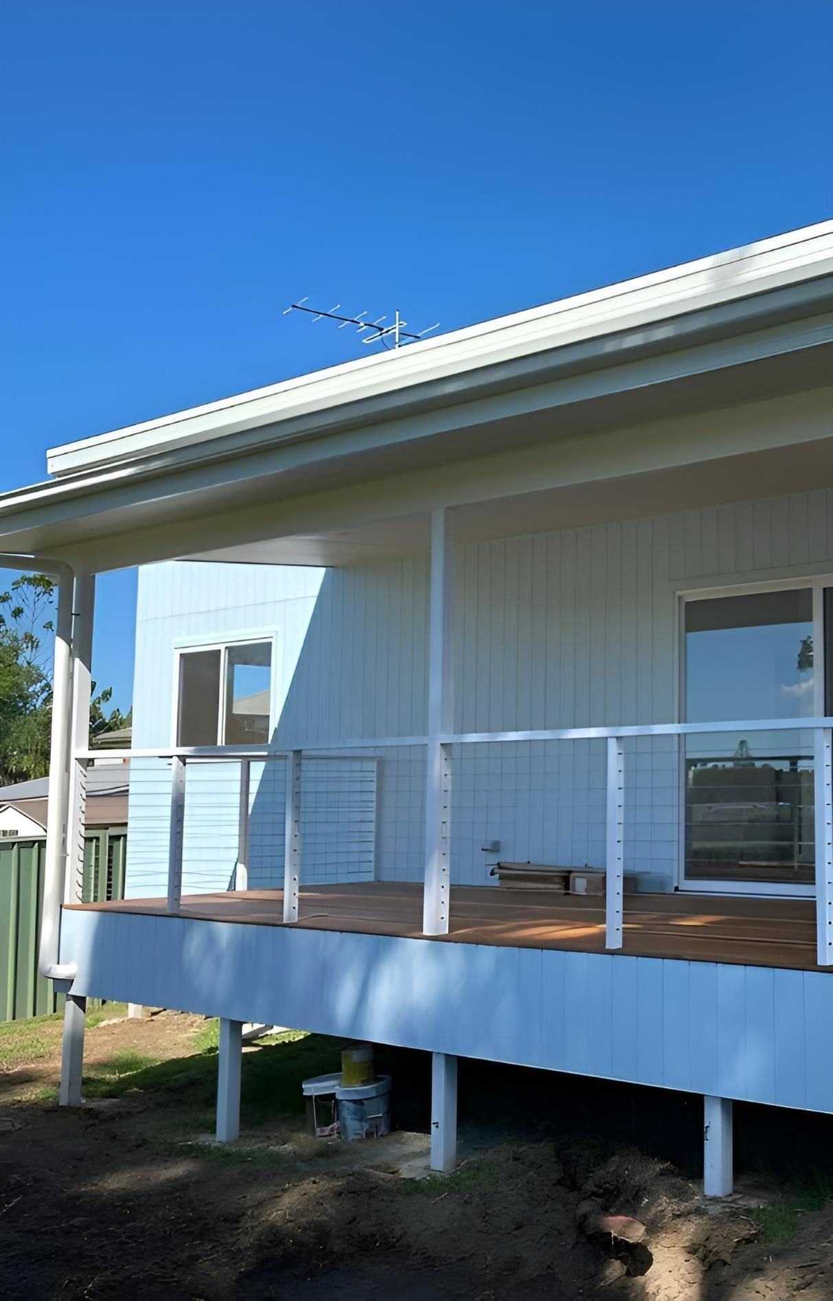 White House With Deck and White Railing — Mid North Coast Drafting & Construction in Taree, NSW