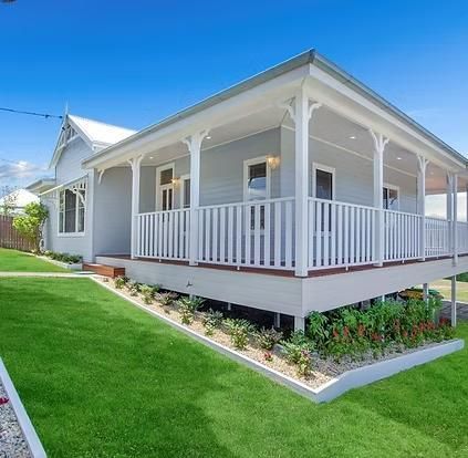 Light Blue House With White Trim and Wraparound Porch — Mid North Coast Drafting & Construction in Taree, NSW