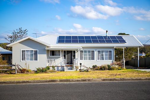 Gray House With Solar Panels on Roof — Mid North Coast Drafting & Construction in Taree, NSW
