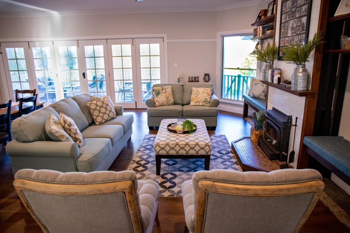 Living Room With Light Blue Sofas, Fireplace, and French Doors — Mid North Coast Drafting & Construction in Taree, NSW
