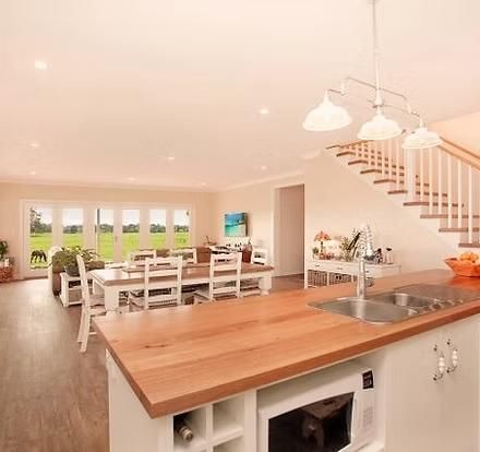 Open-Plan Kitchen and Dining Area With Folding Doors to Green Field — Mid North Coast Drafting & Construction in Taree, NSW
