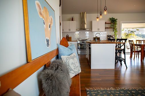 Wooden Bench in Open Kitchen and Dining Area With Artwork — Mid North Coast Drafting & Construction in Taree, NSW
