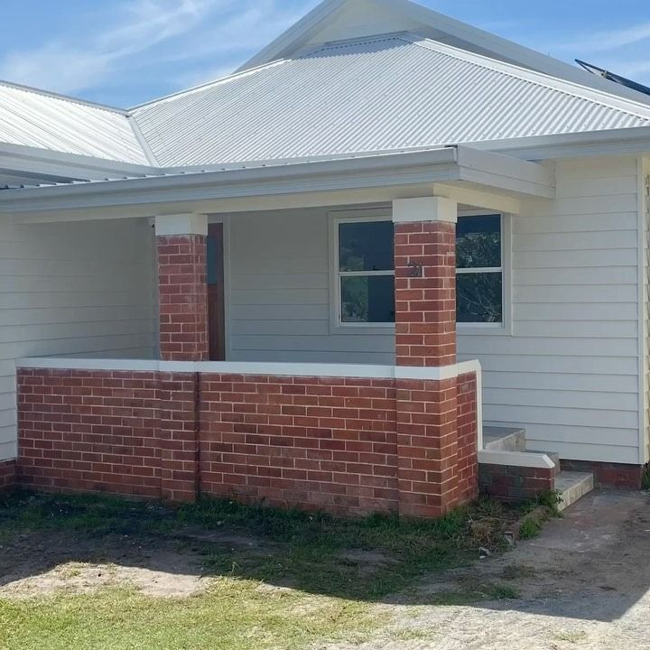 White House With Red Brick Pillars and Porch — Mid North Coast Drafting & Construction in Taree, NSW